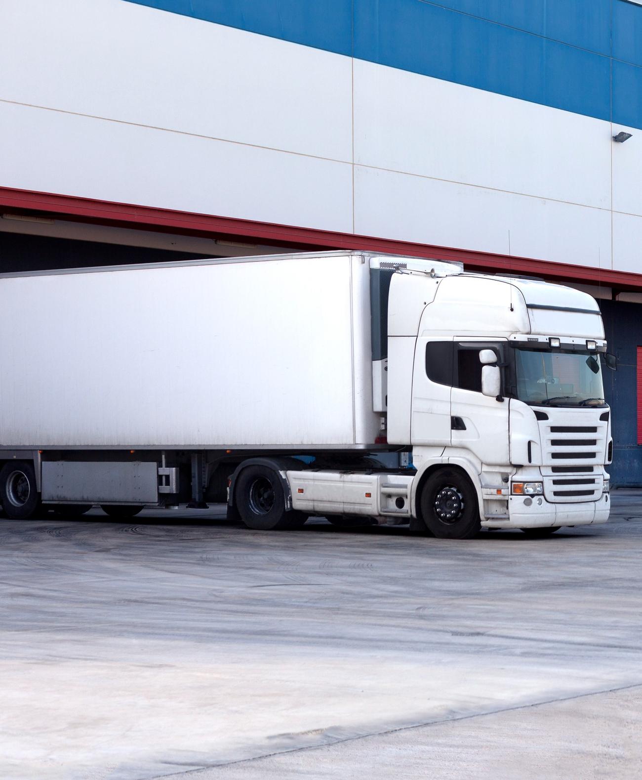 Lkw mit Sattelauflieger an einer Laderampe